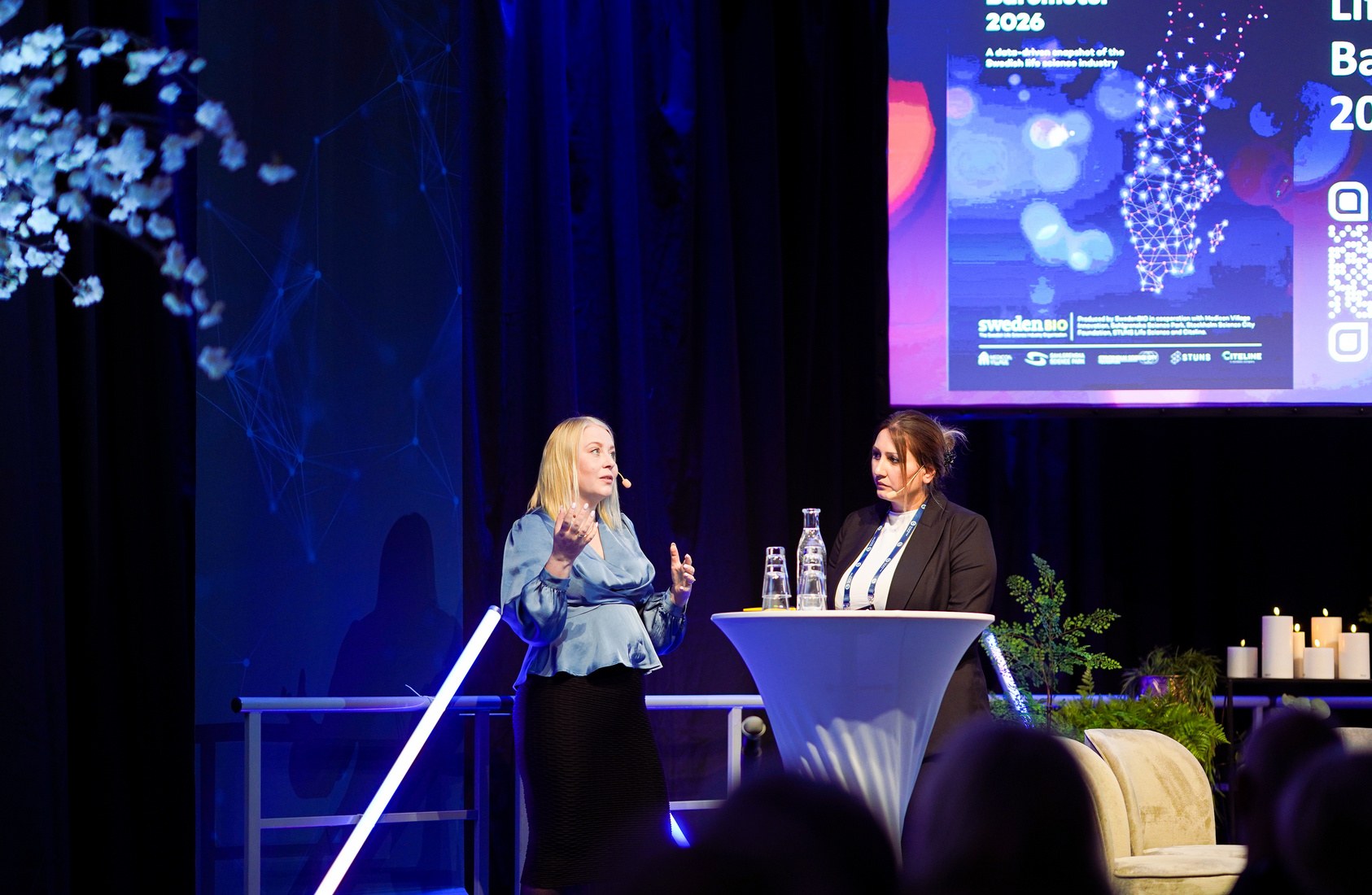 Joanna speaking on stage at a life science conference